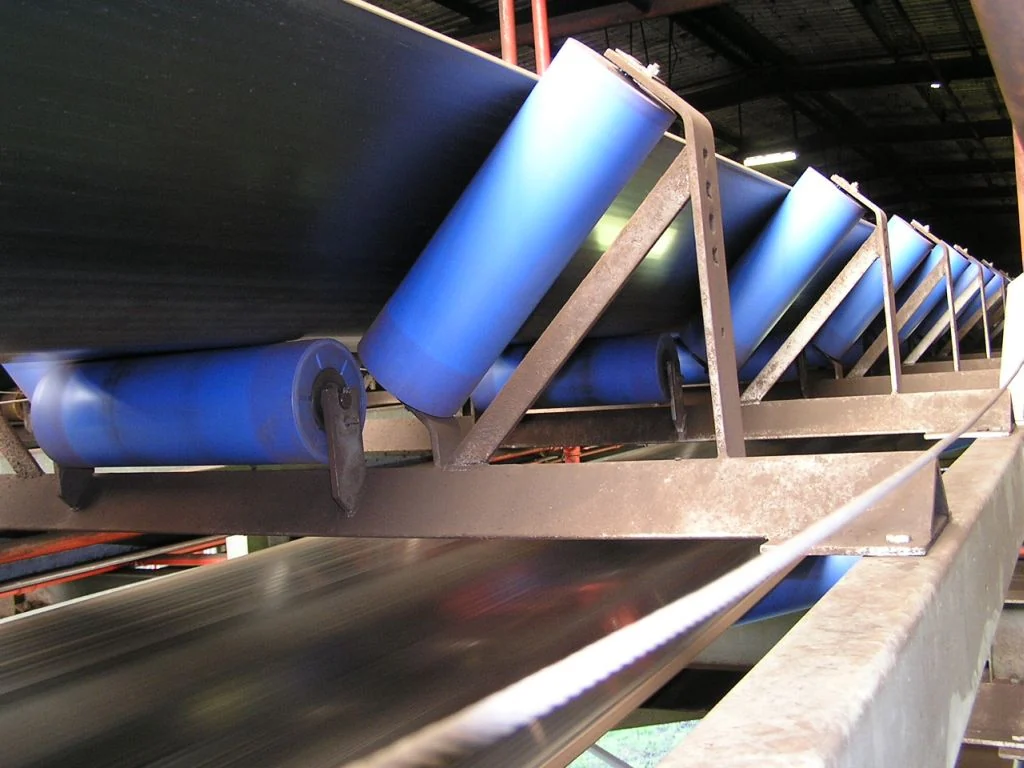 Polymer conveyor rollers installed on a belt system
