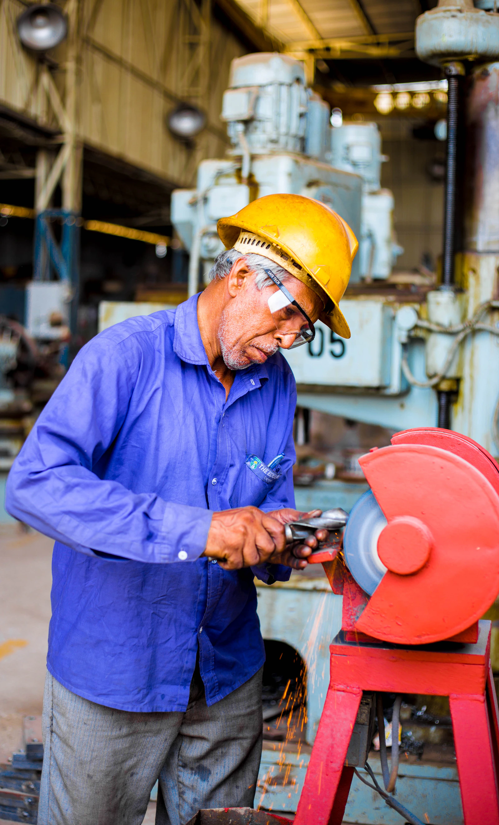 Industrial tradesperson repairing workshop equipment