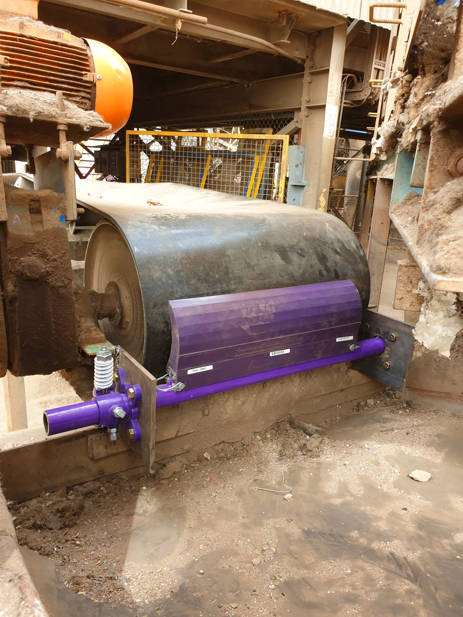 Belt cleaner installed by AMS on a conveyor head pulley